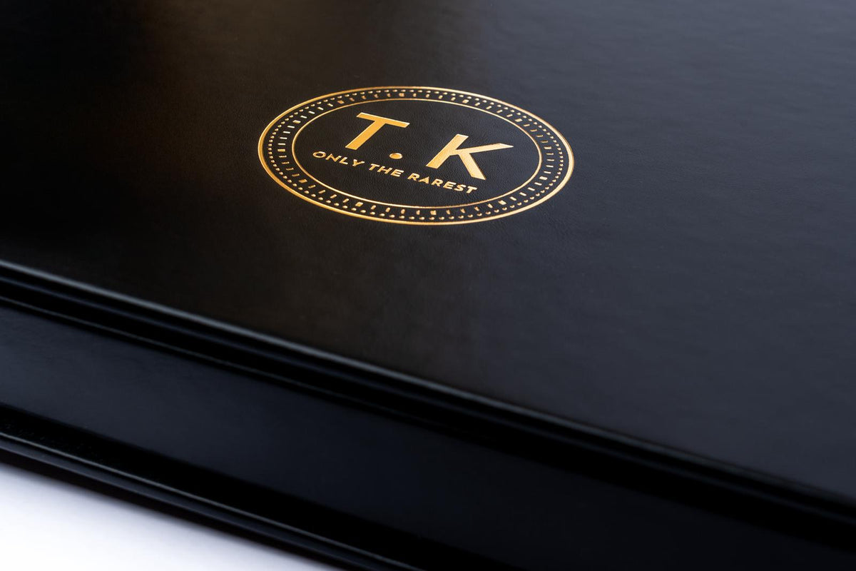 Gold T.K. emblem on the black cover of Only The Rarest