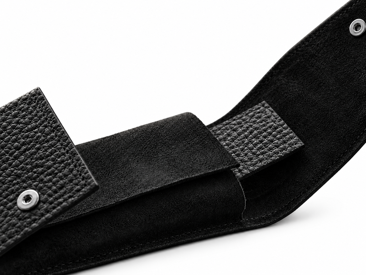 Black suede pouch interior and snap closures on a white background