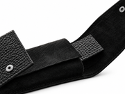 Black suede pouch interior and snap closures on a white background